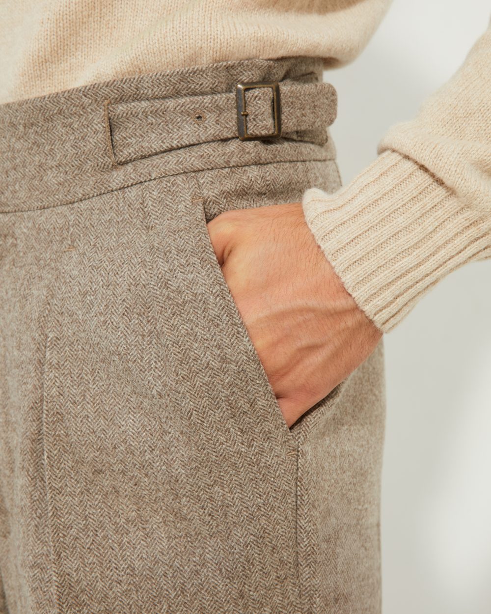 Détail trois-quarts des boucles latérales et des pinces du pantalon Gurkha en flanelle beige Scavini.